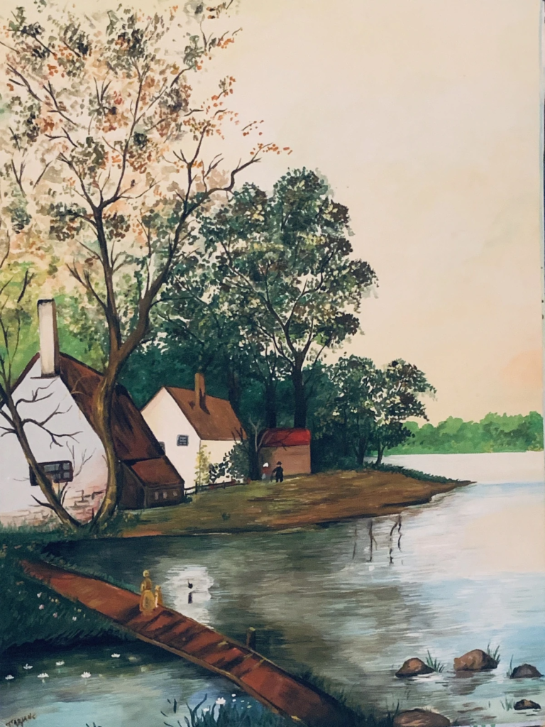 A white watermill and cottages beside calm water, framed by tall trees.